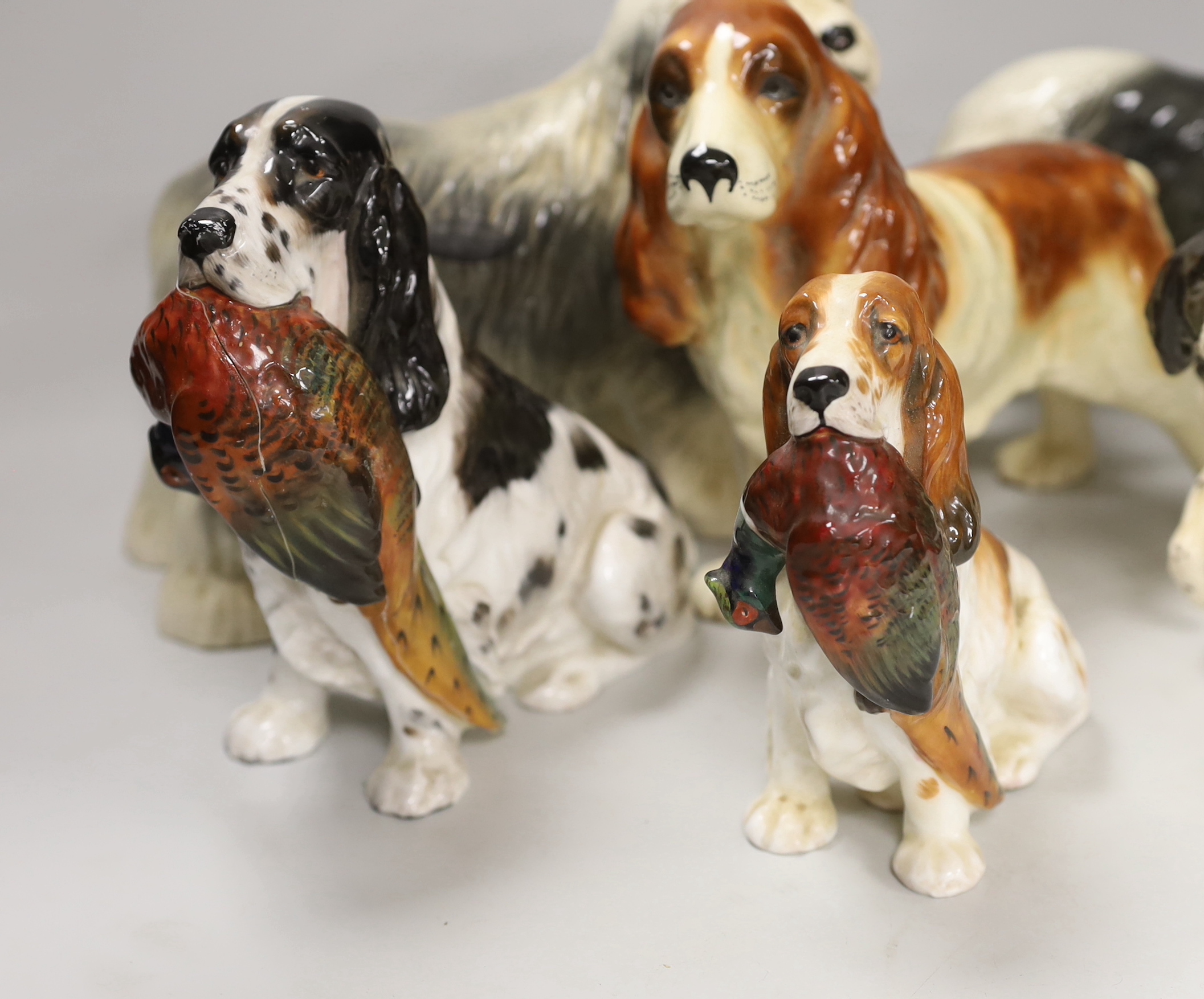 A group of six ceramic models of dogs including Royal Doulton and Beswick